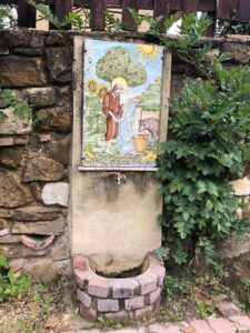 Artwork of St Francis and the Wolf water fountain, found on the pilgrimage route out of Gubbio